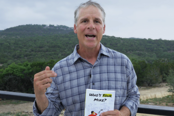 Kurt Wilkin holds his new book, Who's Your Mike?